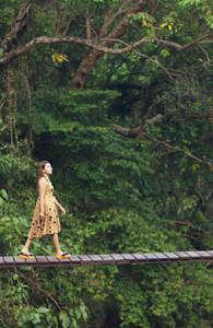 thailand-jungle-woman-walking-wooden-bridge