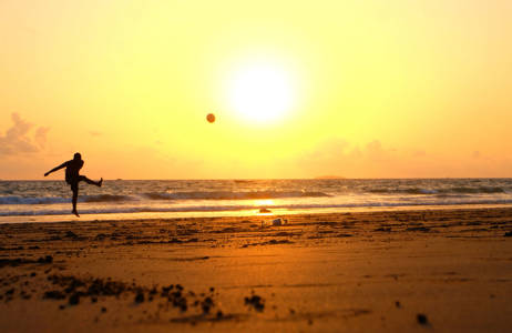 myanmar-man-kicking-ball-at-beach-sunset
